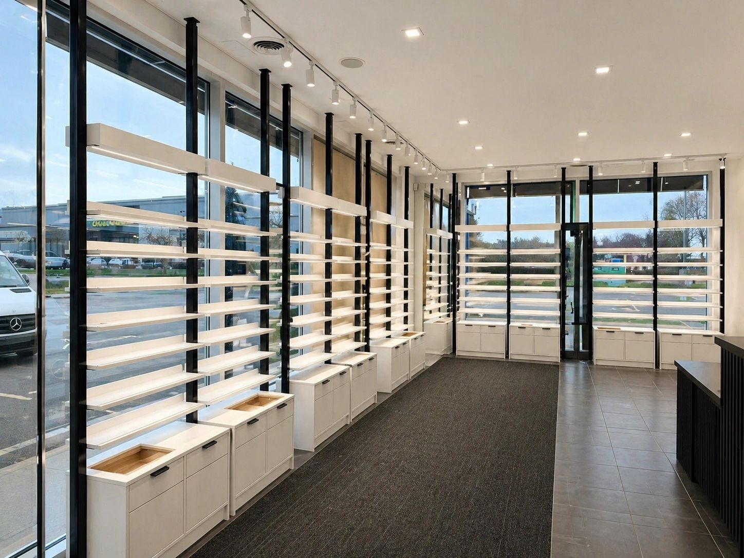 Empty modern retail display with large windows and shelves.