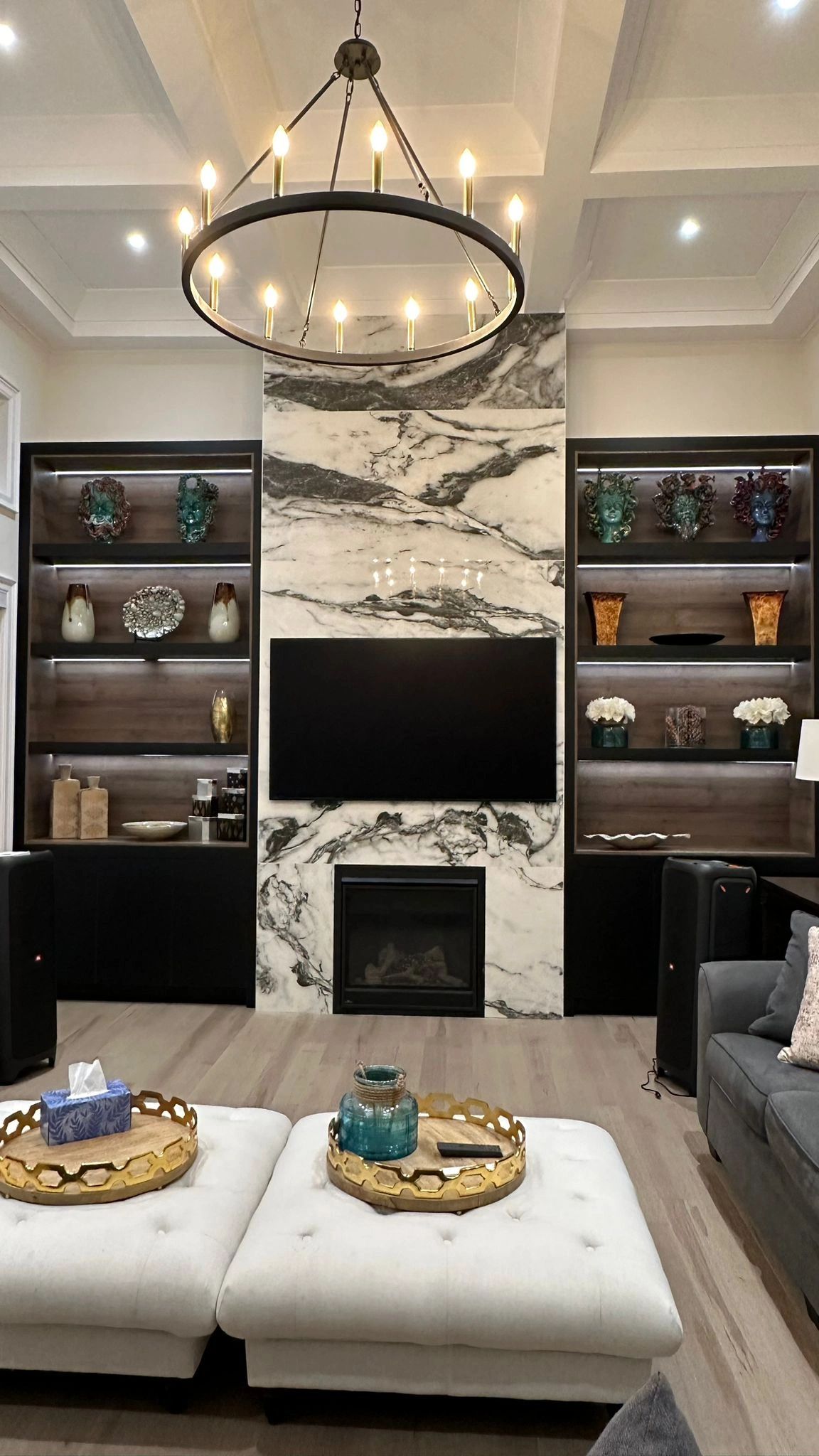 Modern living room with marble fireplace and chandelier