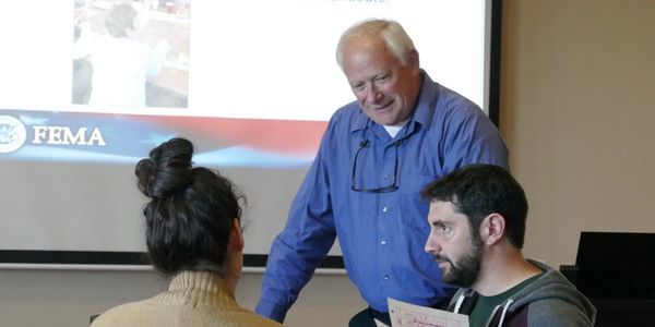 Chief Bernie Paul coaches members of a small work group during an advanced incident command course