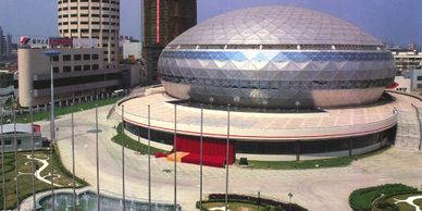 A futuristic dome-shaped building in an urban area.