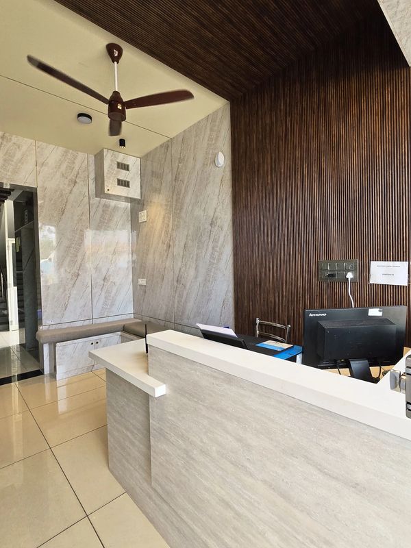 Modern office reception area with wooden and marble wall accents.