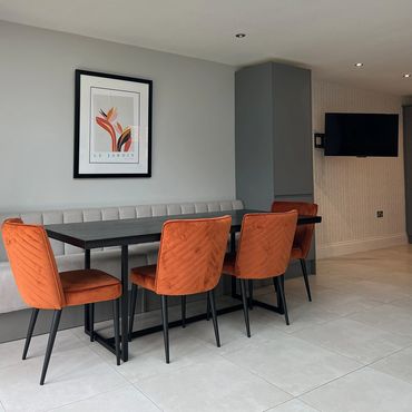Kitchen bench seating with dining table and chairs in a large open plan area.
