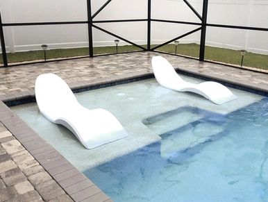 Picture of White Pool Lounger on Deck by Pool.