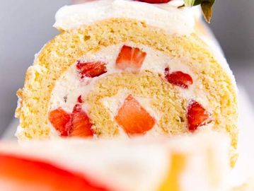 Strawberry cream Swiss roll cake slice.