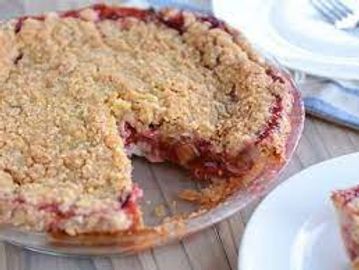 A slice is missing from a crumb-topped fruit pie on a glass plate.