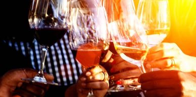 People clinking wine glasses in a celebratory toast.