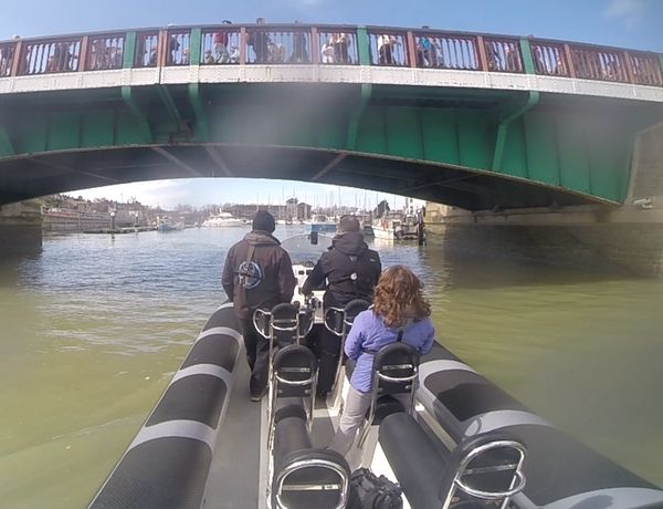Our RIB Buccaneer going under Weymouth town bridge with a group of students