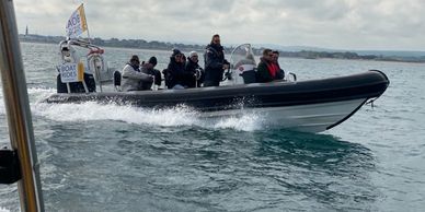 Powerboat at speed with a group of people off for a day trip along the coast 