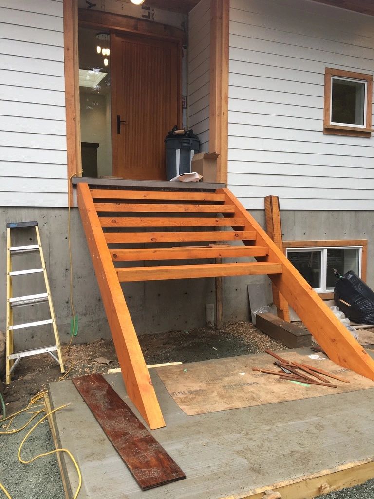 Cedar entry stairs under construction on a DM Patterson job site