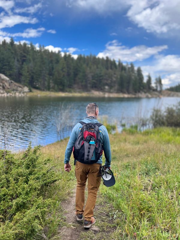 A man walking towards the river