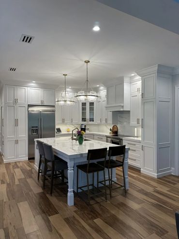 Full kitchen remodel with custom white cabinets.