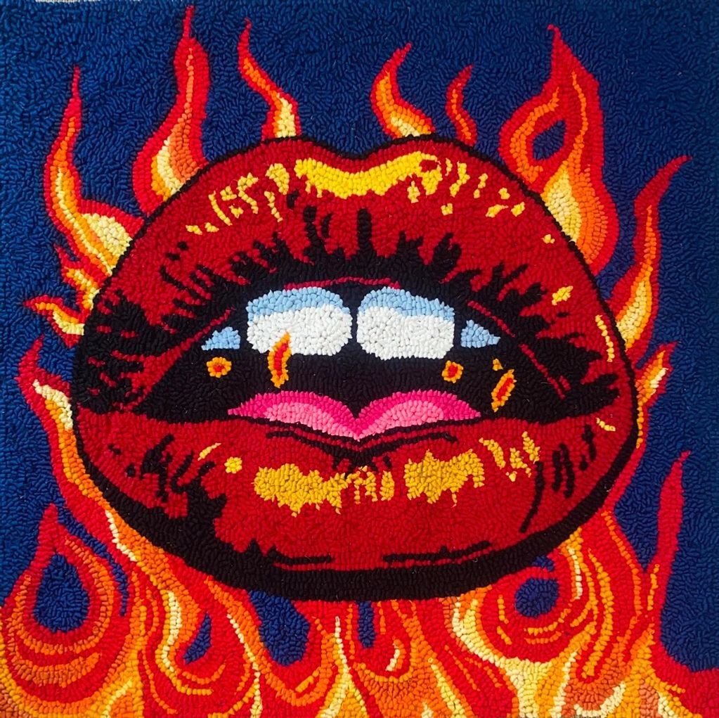 Red lips parted showing teeth and tongue encased in flames.
