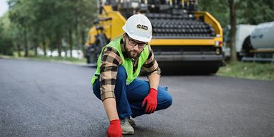 SBI Contractor  inspecting asphalt crack repair and seal coat to ensure professional quality work.