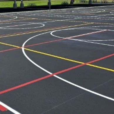 Line stripping asphalt in a school playground in Bakersfield, CA.  Allowing children to play safely.