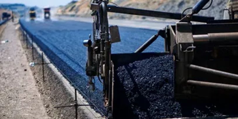 A closeup look at a road making machine.