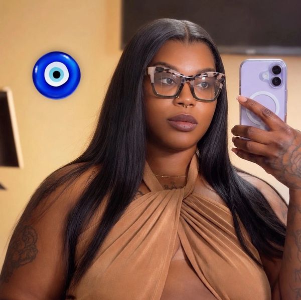 Woman with long hair taking a selfie in glasses.