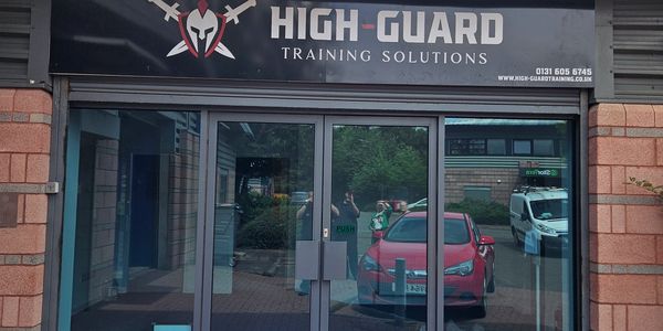 Entrance of High-Guard Training Solutions with glass doors.