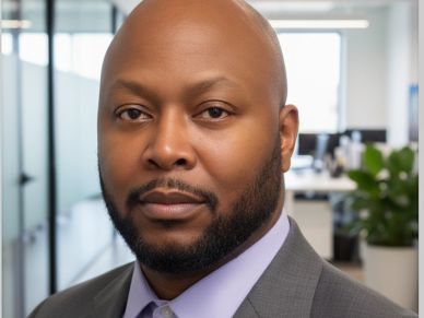 Professional portrait of a confident man in office attire.