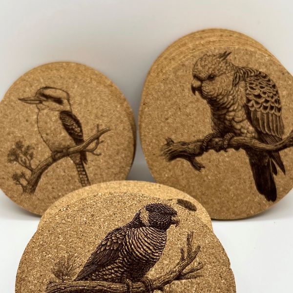three cork coasters with birds on them