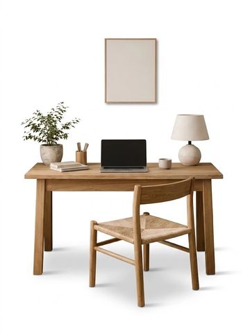 Minimalistic wooden desk setup with a plant and lamp.