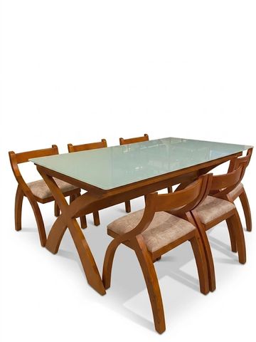 Wooden dining table set with glass top and six chairs.