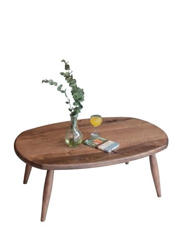 Wooden table with a vase, book, and drink.