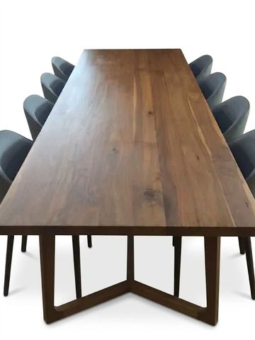 Long wooden dining table with chairs.