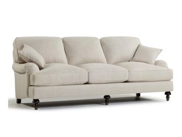 Beige three-seater sofa with cushions.