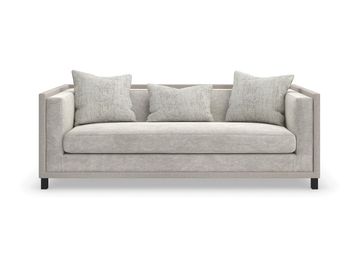 Modern light gray sofa with three matching cushions.