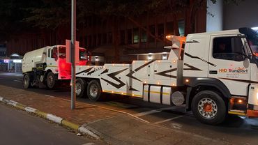 MHD Transport tow truck recovering a road sweeper in Cape Town at night