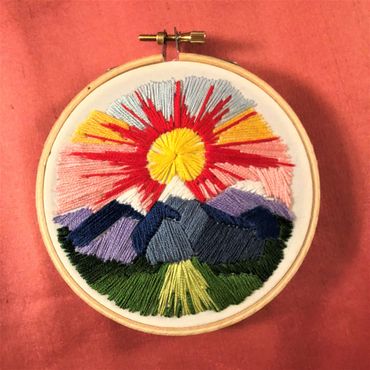 embroidery of sunset over mountains