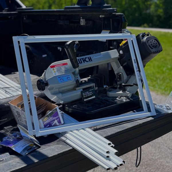 Power saw and aluminum frames on a truck bed.
