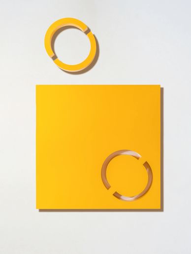 Yellow square with circular cutouts on a white background.