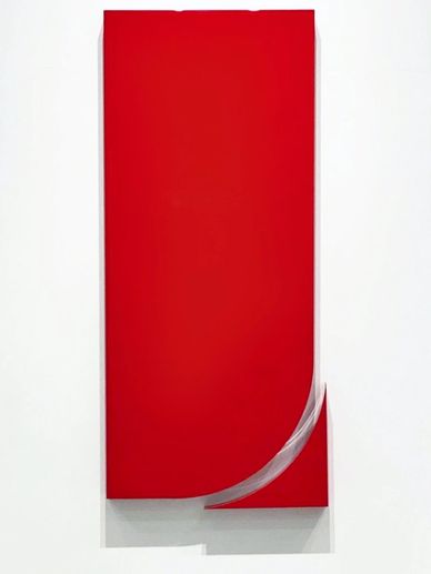 Minimalist red canvas with a curled corner revealing a white underside.
