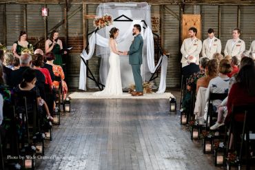 Bride and groom holding hands at wedding ceremony.