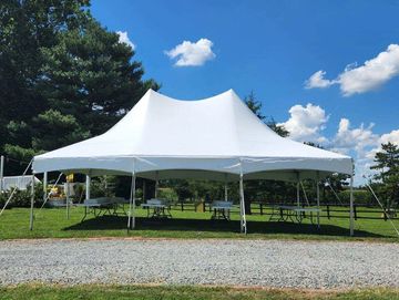 20x30 Frame tent with 8 ft banquet tables, white folding chairs.