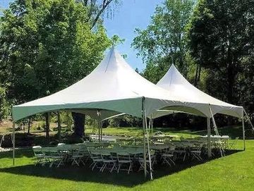 20x40 Frame tent with 8 ft banquet tables, white folding chairs.