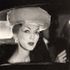 1950's black and white vintage fashion photo of American super model Dovima, sitting in a car .
