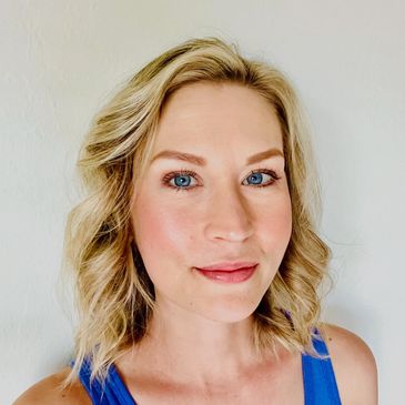 Smiling woman against a textured background.