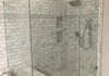 Custom Frameless Shower Door with Step up and 90 Degree Return