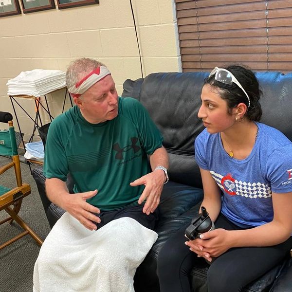 Two people engaged in a conversation indoors.