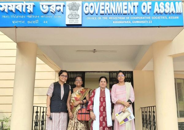 Four women standing outside the Government of Assam cooperative societies office.