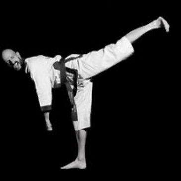 Man doing a high karate kick.