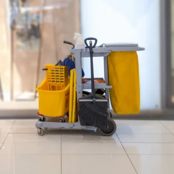 Janitorial cart on a white shiny tiled surface