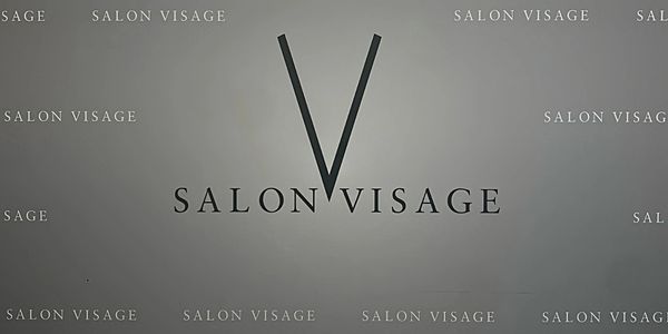 Minimalist logo design for Salon Visage with a large 'V'.