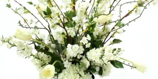 Artificial floral arrangement in white