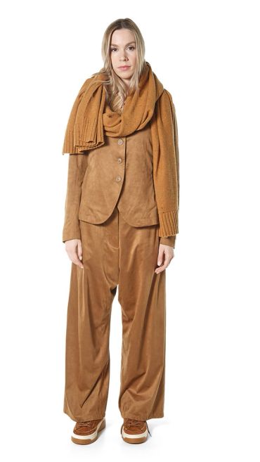 Woman in brown outfit with scarf and pants.