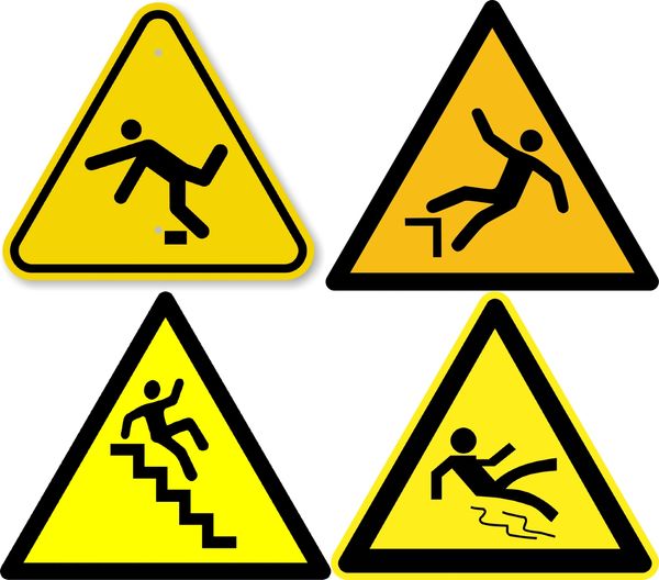 Four yellow caution signs warning about slipping and falling hazards.