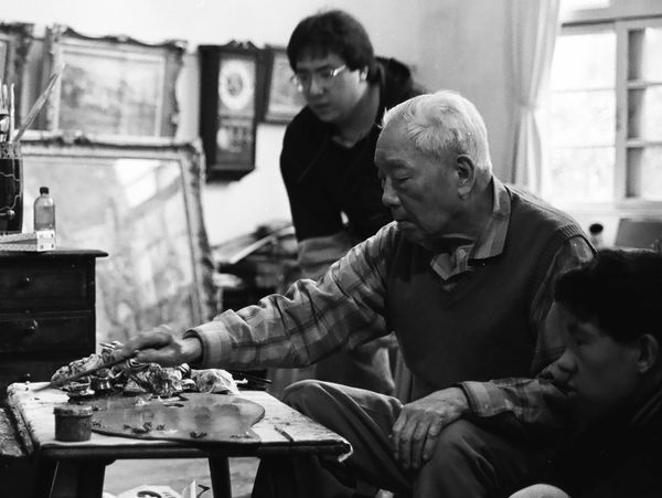 Christopher K. Young/楊啟明 receives painting instruction from his grandfather Yang San Lang/楊三郎, 1992