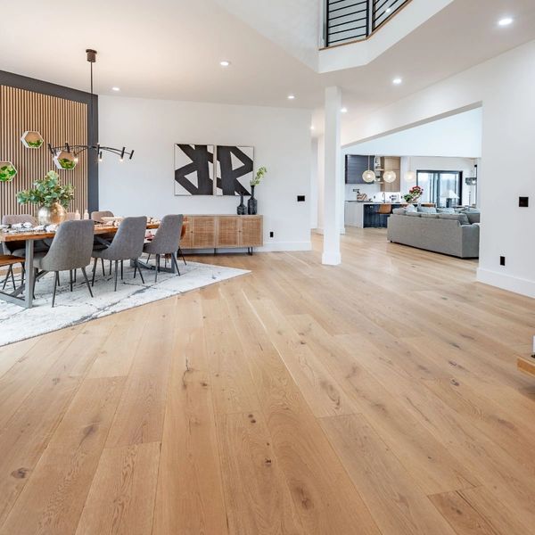Modern open living and dining area with wooden flooring.